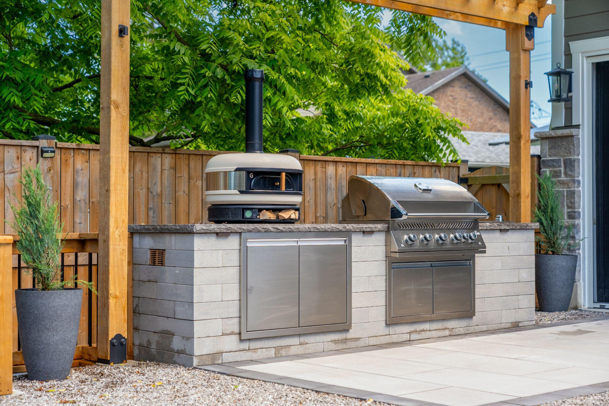 Custom outdoor kitchen with built-in grill and pizza oven