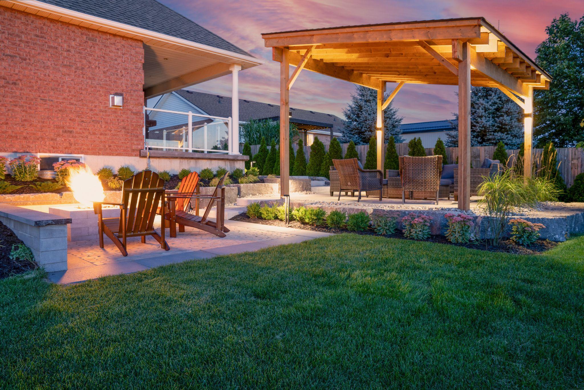 Pergola-covered seating area with fire feature at sunset